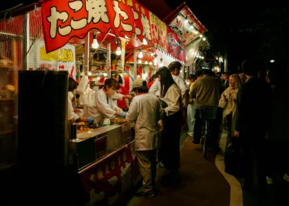 People line up at a japanese food stall.