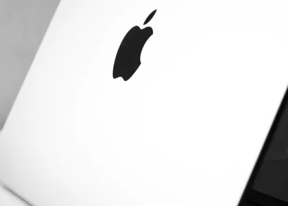 a black and white photo of an apple laptop