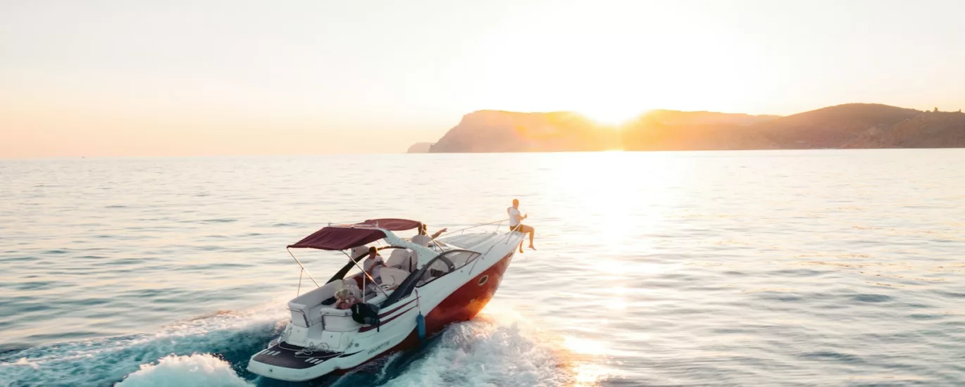 man riding on white and red boat on sea during daytime