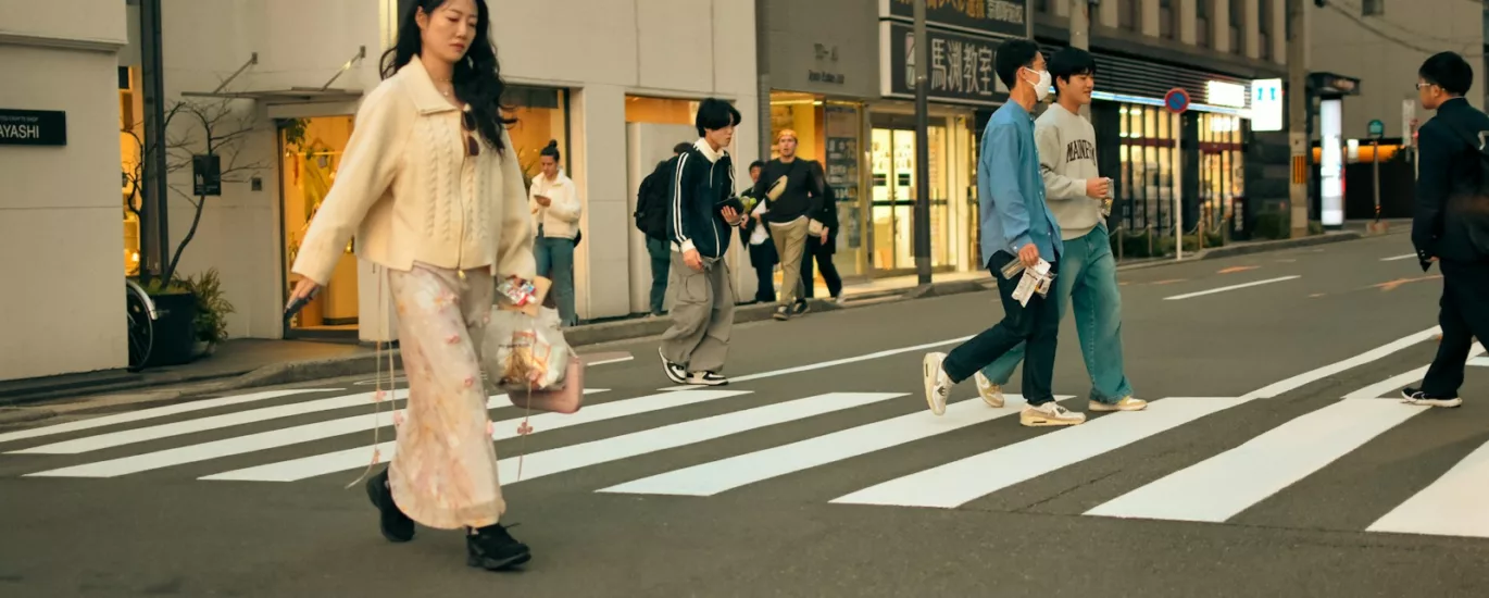 People crossing a street in an urban setting.