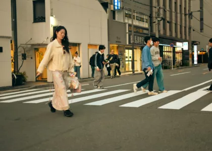 People crossing a street in an urban setting.