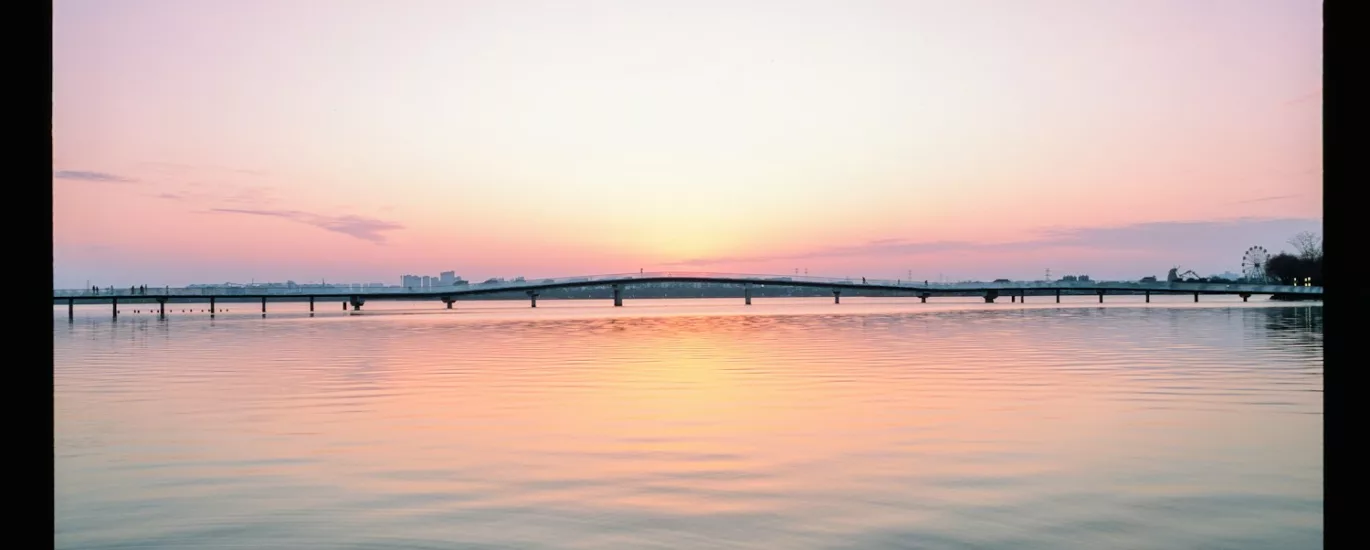 Beautiful sunset reflects over a tranquil lake.