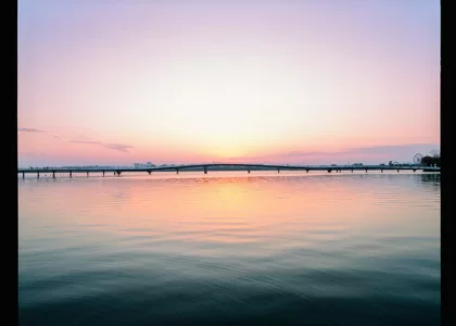 Beautiful sunset reflects over a tranquil lake.