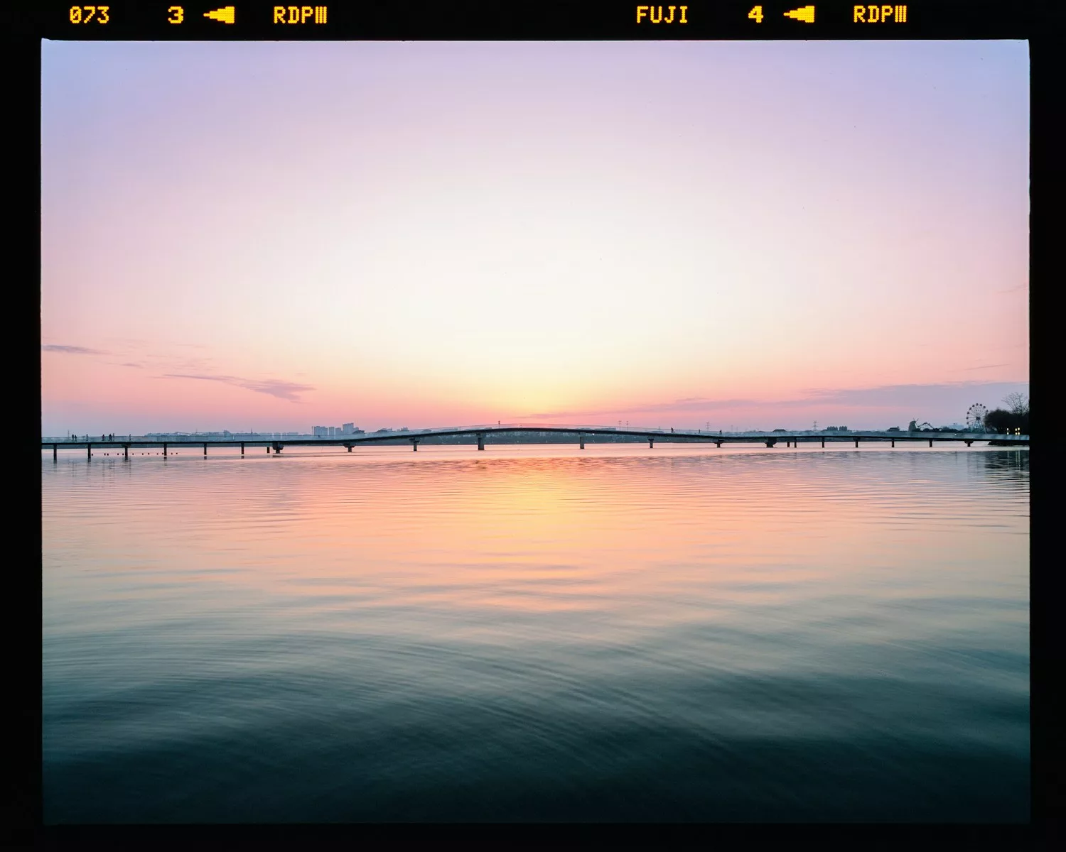 Beautiful sunset reflects over a tranquil lake.