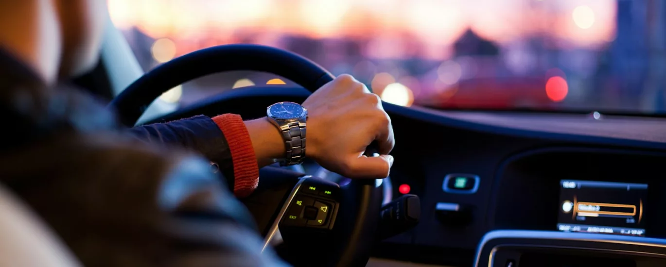 man driving a car wearing wrist watch