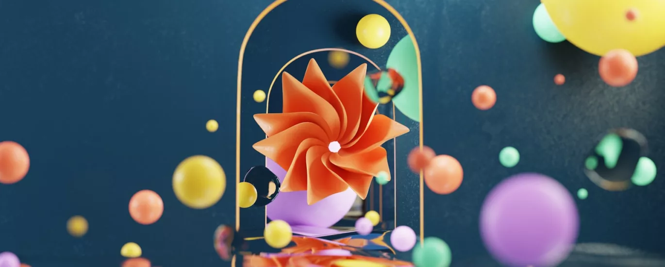 a birdcage with a bow on it surrounded by balloons