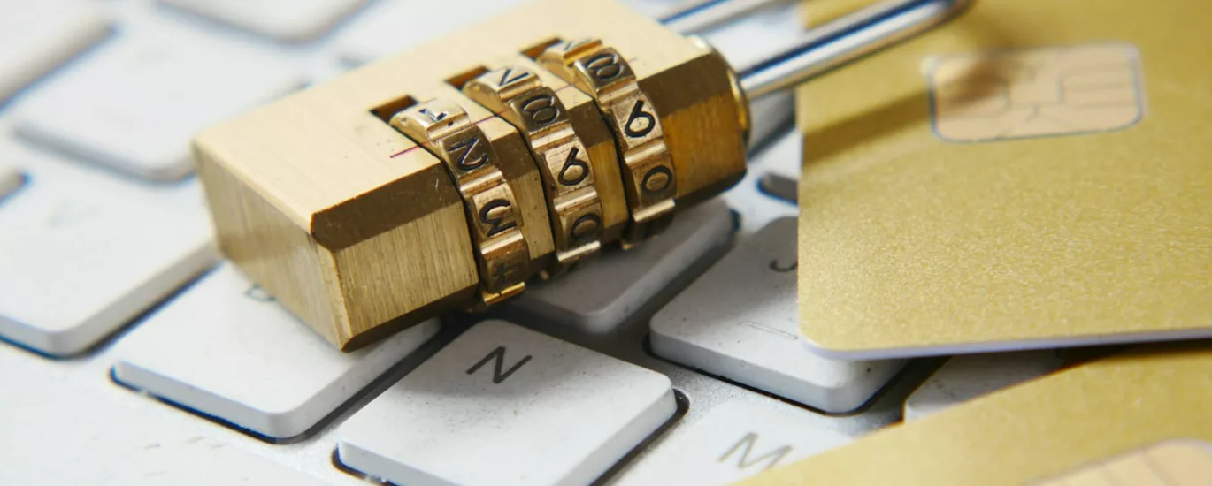 a golden padlock sitting on top of a keyboard