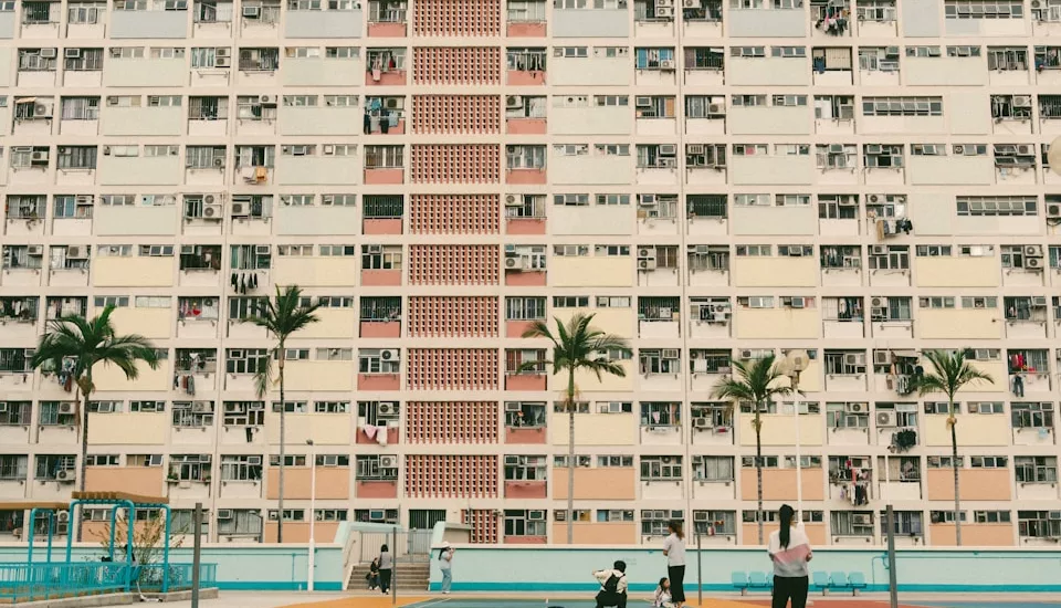 A vibrant badminton court in front of a large building.