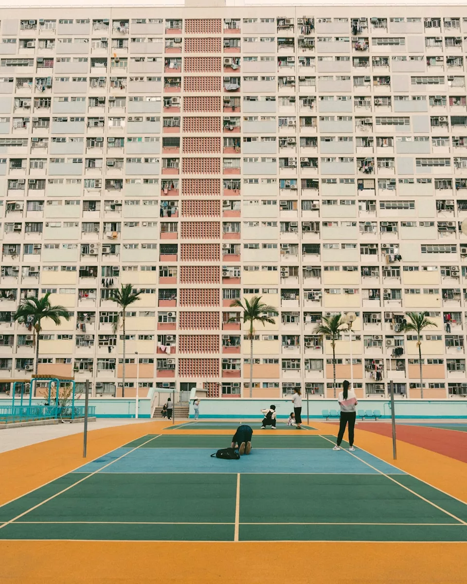 A vibrant badminton court in front of a large building.