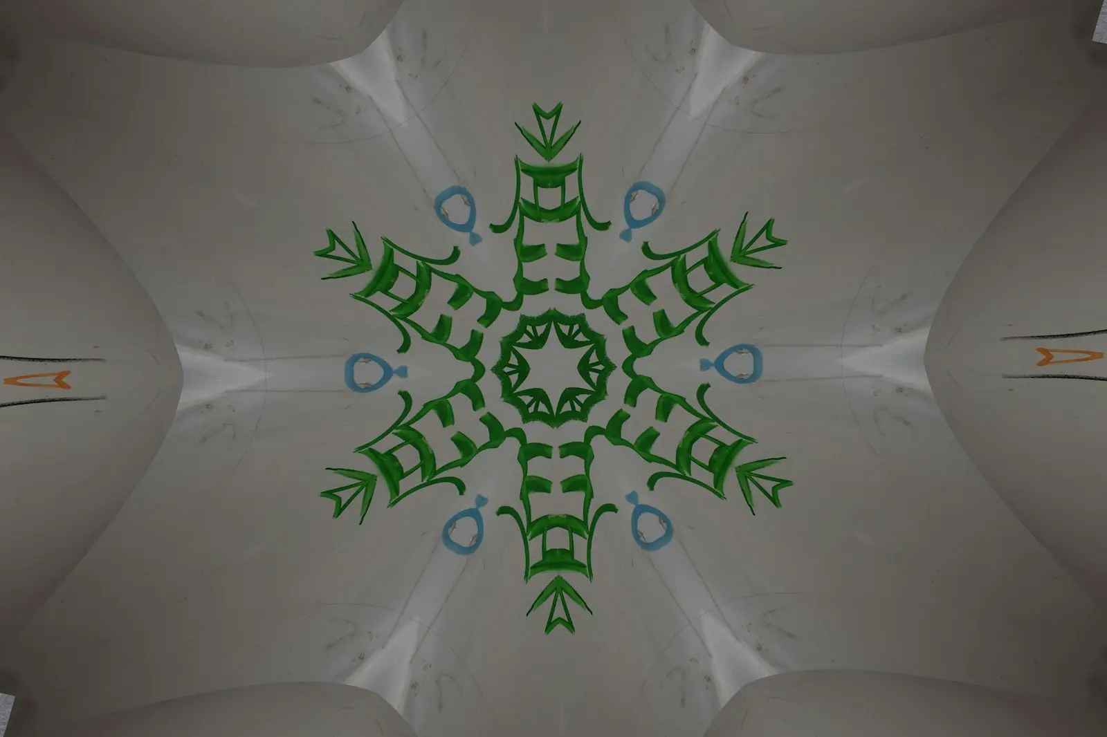 A kaleidoscope design with a green and blue pattern.