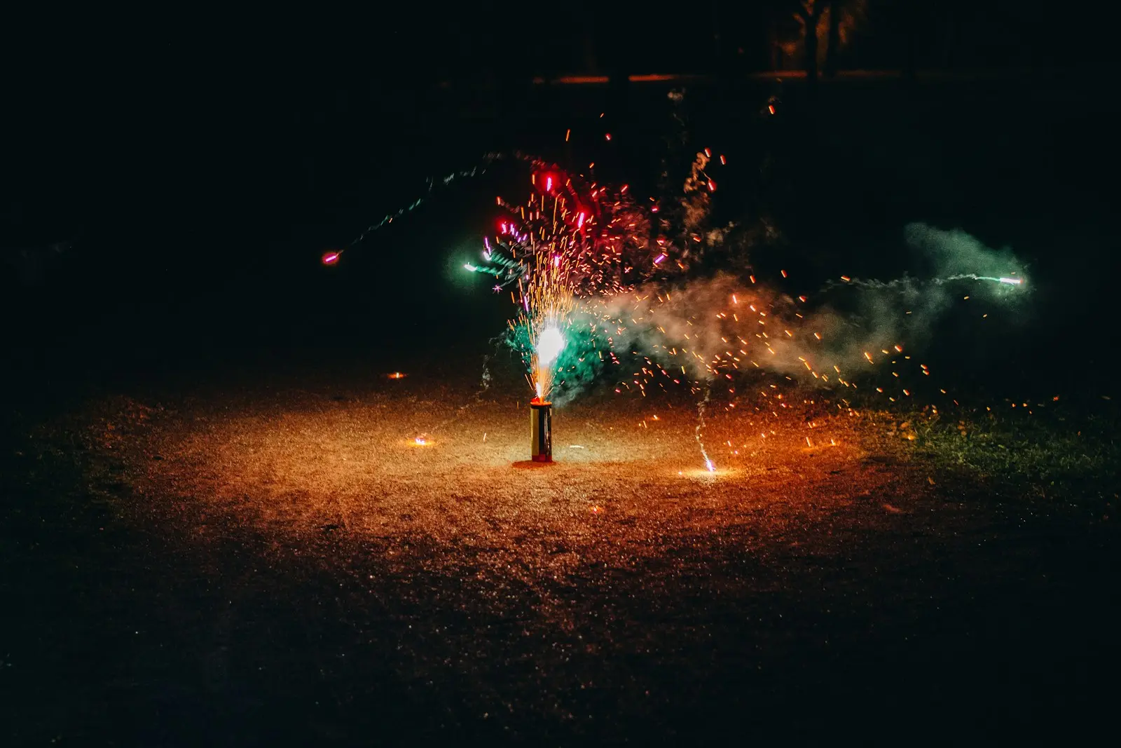 a firework is lit up in the dark
